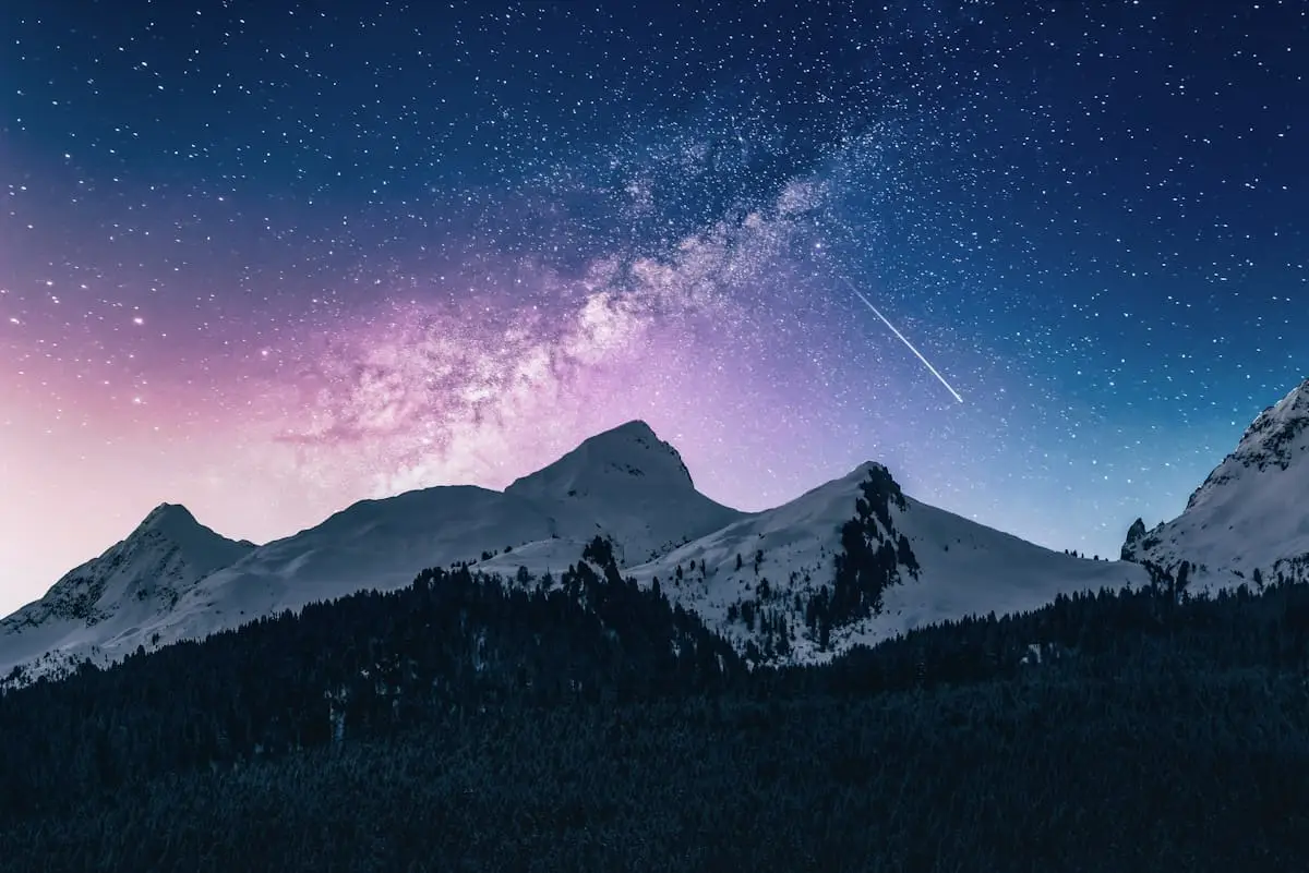 Starry night above mountain peaks